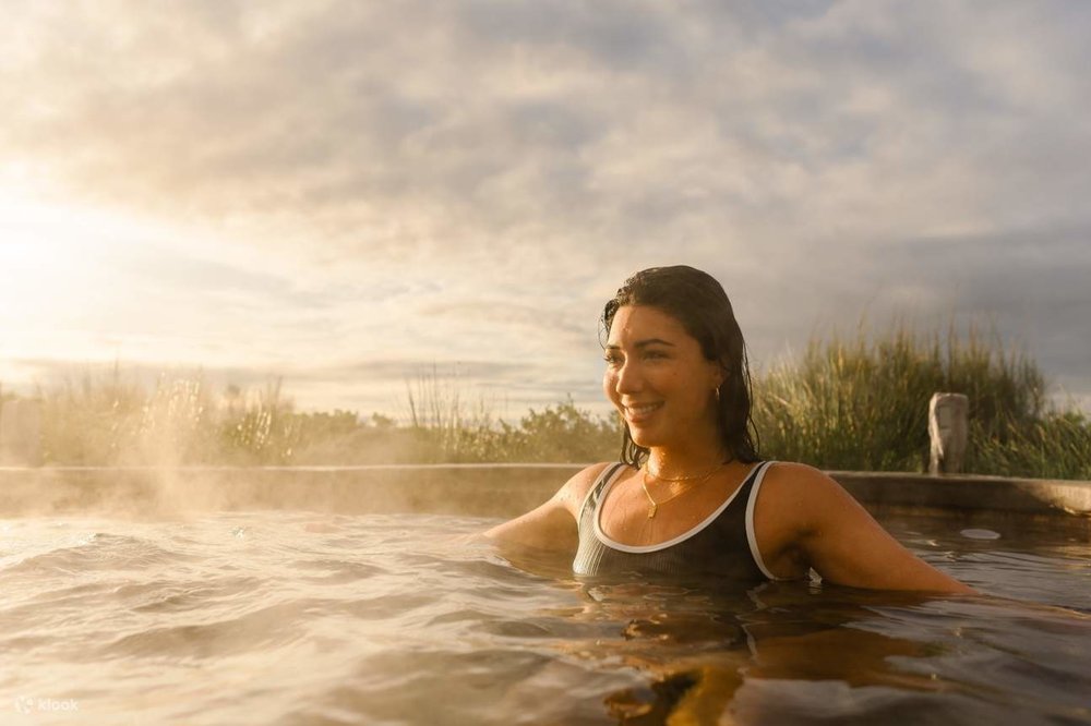 A woman sat inside a tub at the Peninsula Hot Springs