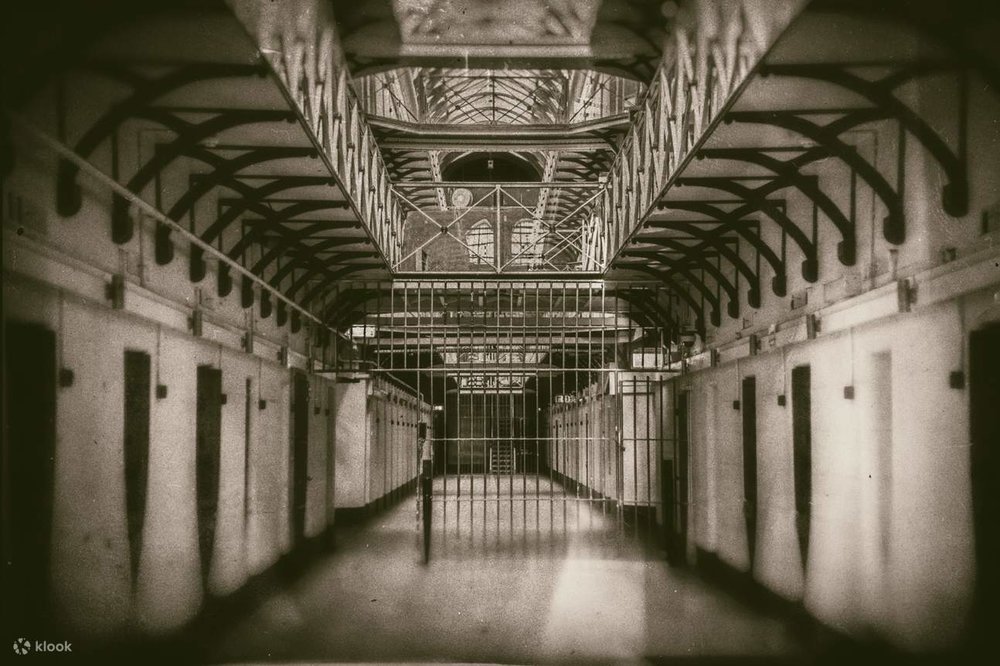 A black and white photo of a prison hallway
