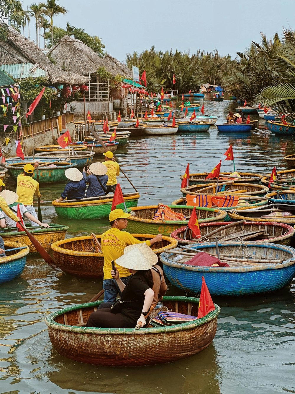 Crowd of colorful coconut basket boats at the dock in Hoi An