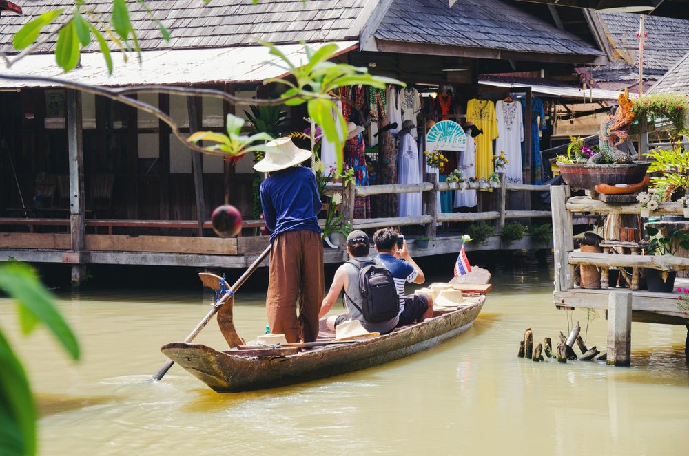 Boat ride through Pattaya Floating Market past shops and wooden walkways