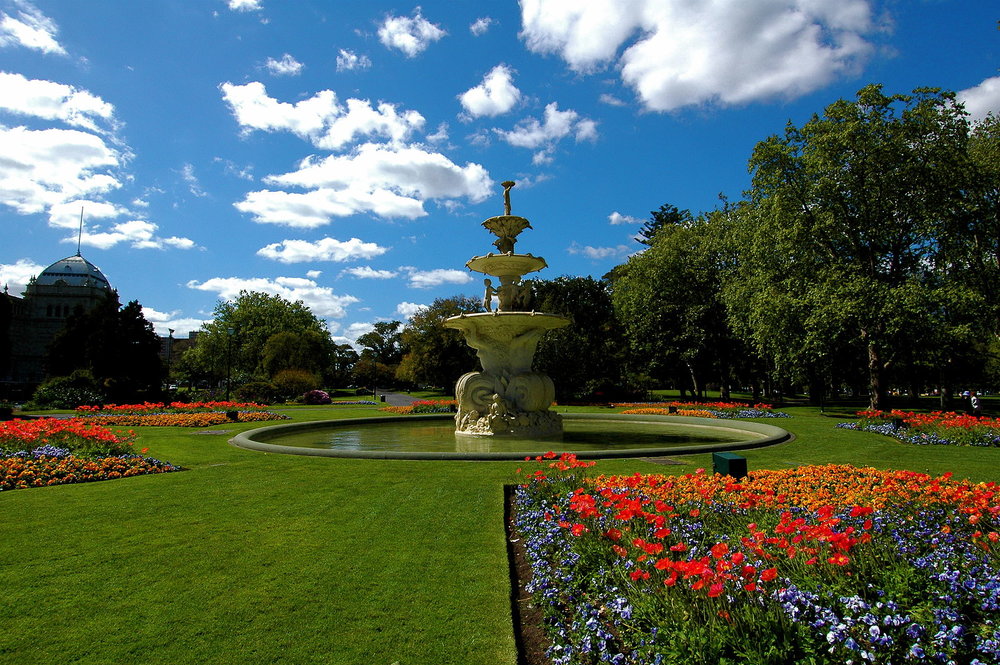 Carlton Gardens fountain with colorful spring flowers and trees