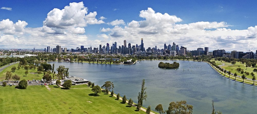 Wide aerial shot of Albert Park Lake with Melbourne skyline