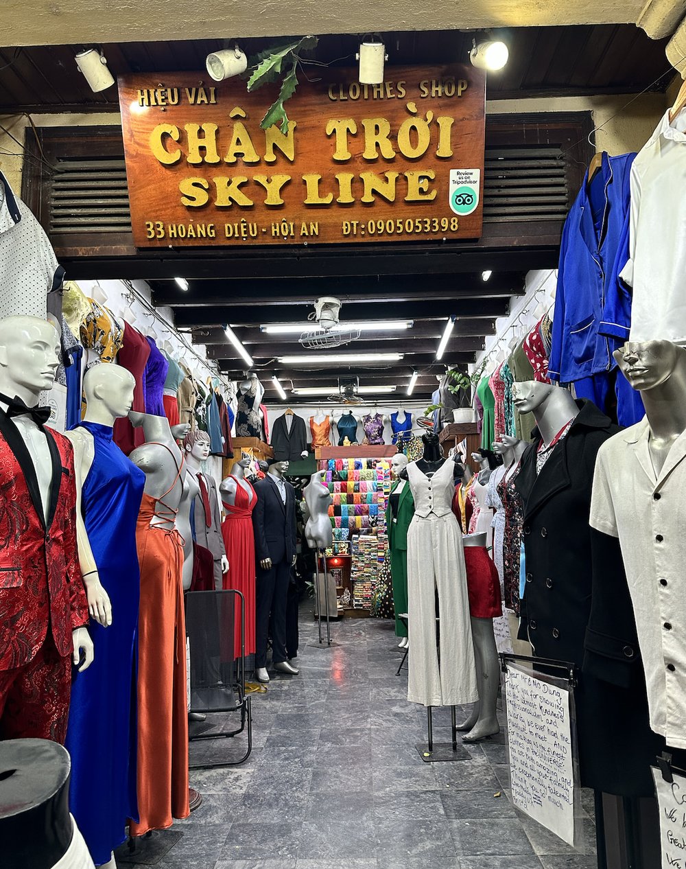 insided hoi an cloth market shop with silk clothing tailor-made