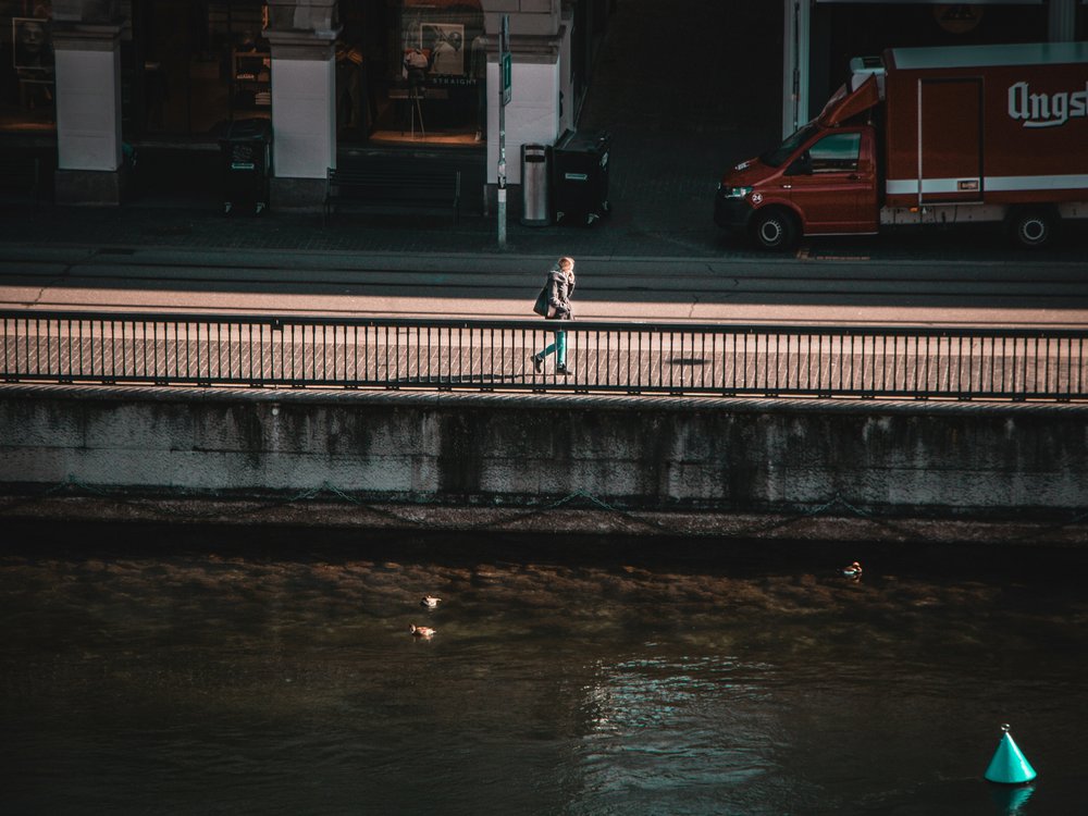 A woman walking by the river 