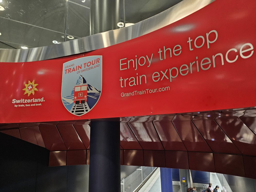 Red Grand Train Tour of Switzerland sign promoting scenic rail journeys
