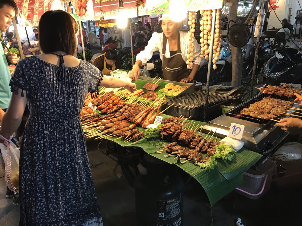 A lady buying food at a night market stall in Patong