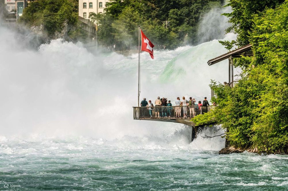 A group of people looking at the Rhine Falls from the panoramic lift