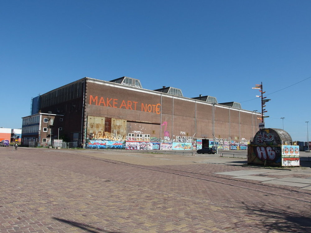 Large graffiti-covered building at NDSM Wharf in Amsterdam Noord