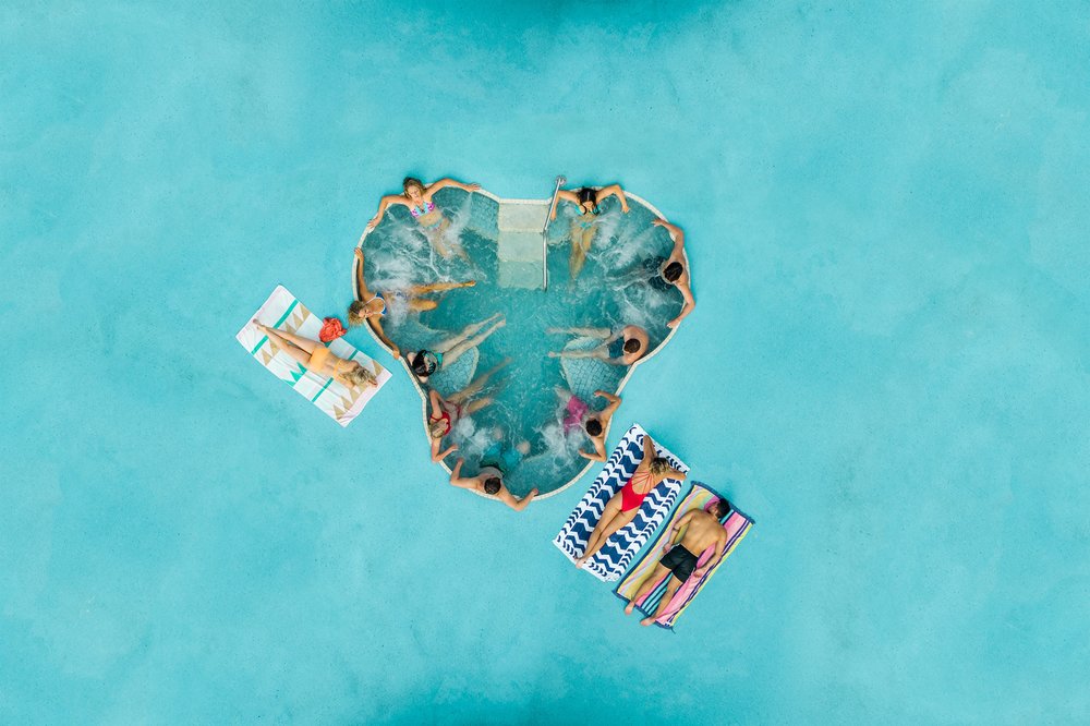 Guests lounging and soaking in a sunny Wet’n’Wild pool on the Gold Coast