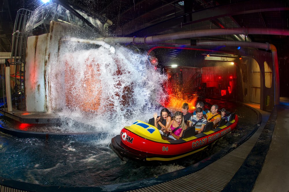 Family on a Sea World boat ride as water splashes dramatically around them
