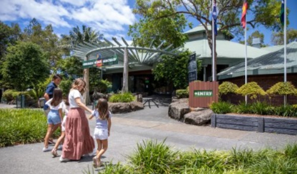 A family walking along the streets of Currumbin Wildlife Sanctuary.