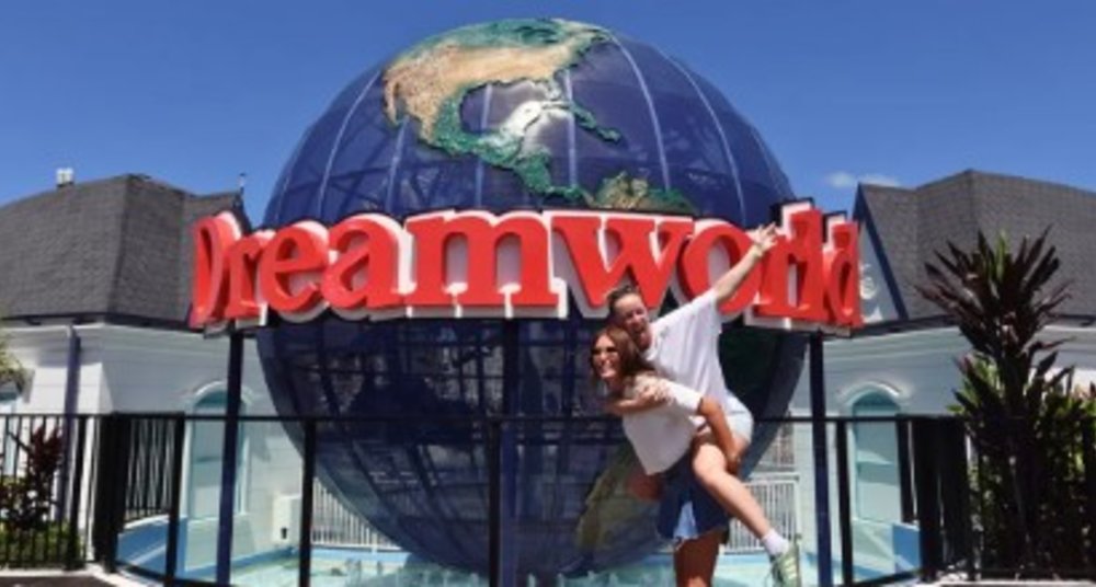 A couple posing in front of Dreamworld’s Huge Globe.