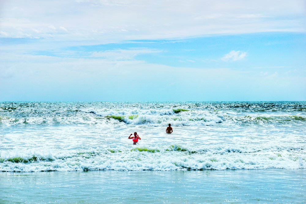 Waves crashing on the shore of Patong Beach.