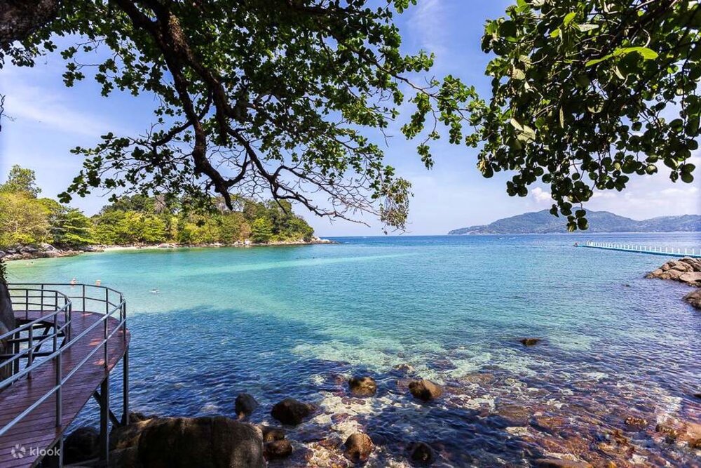 A shaded area of Paradise Beach in Phuket, overlooking the calm turquoise waters.