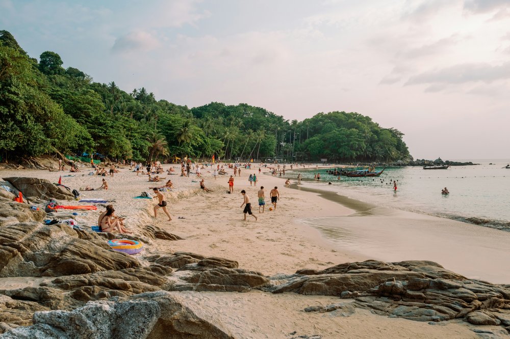 Beachgoers walking on the soft, powdery sand at Freedom Beach.