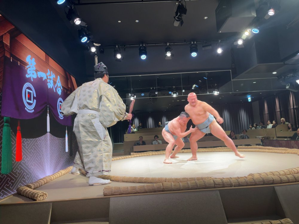 Former sumo wrestlers performing a live match at Hirakuza Ginza