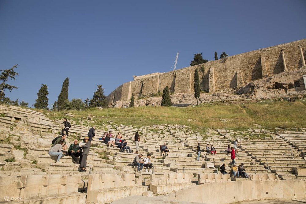 Tourists visiting the ancient Theatre of Dionysus in Athens, Greece