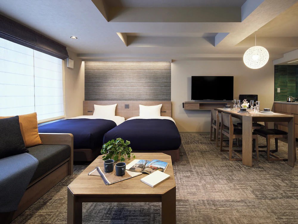 Modern twin room at MINN Gion with dining area and cozy seating