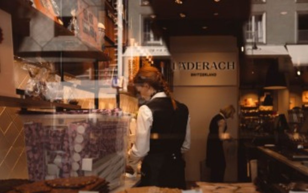 Two Läderach employees working on the store’s chocolates.