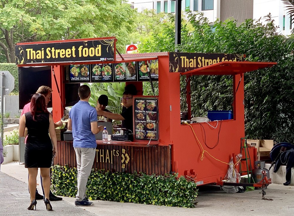 Thai street food stall serving quick meals along the Brisbane to Gold Coast route.