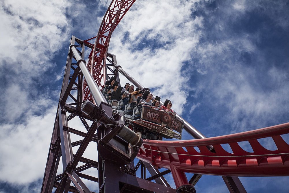 Roller coaster ride at a Gold Coast amusement park under a blue sky