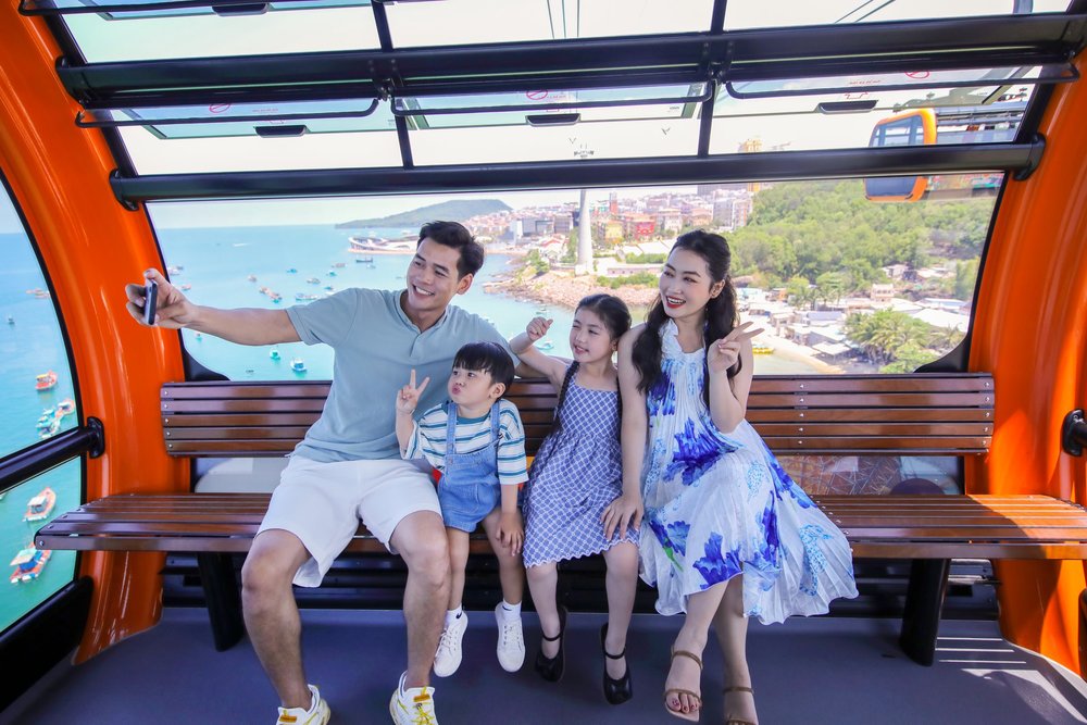 Family riding the Phu Quoc cable car with ocean and island views below