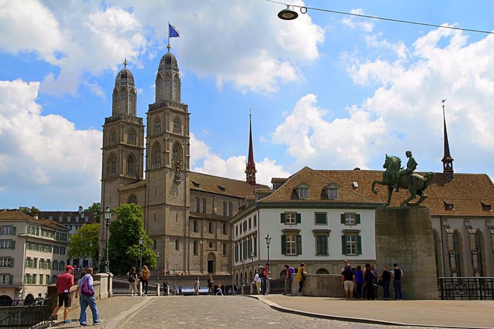 Zurich Old Town featuring Grossmünster church and historic buildings under a blue sky