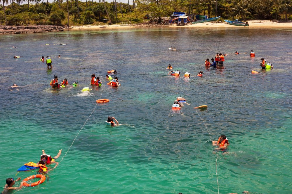 Travelers snorkeling in clear waters near Phu Quoc island