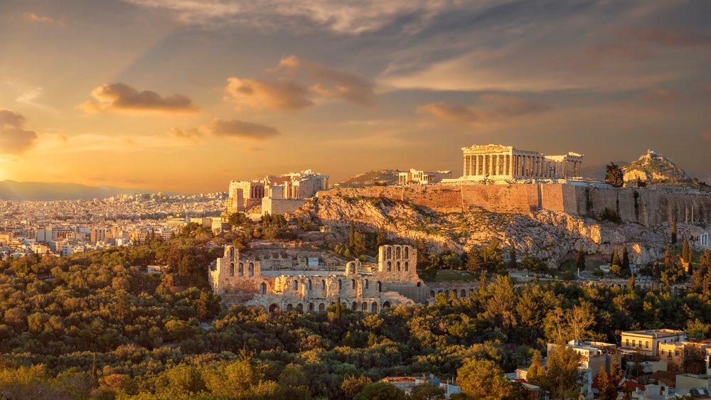 Acropolis of Athens glowing at sunset with city skyline