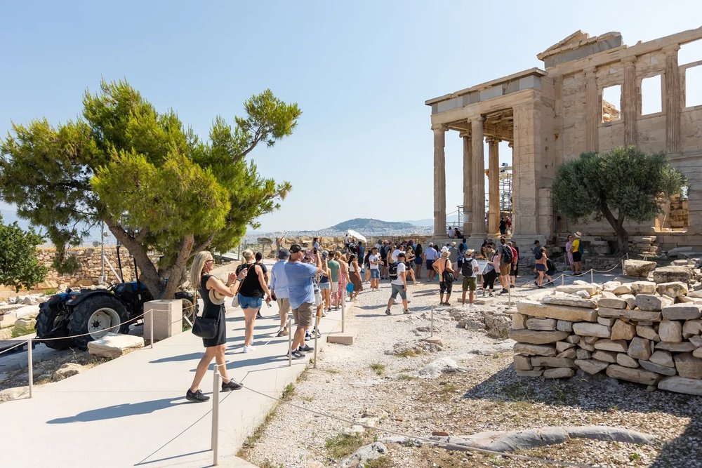 Tourists walking through the Acropolis of Athens ruins