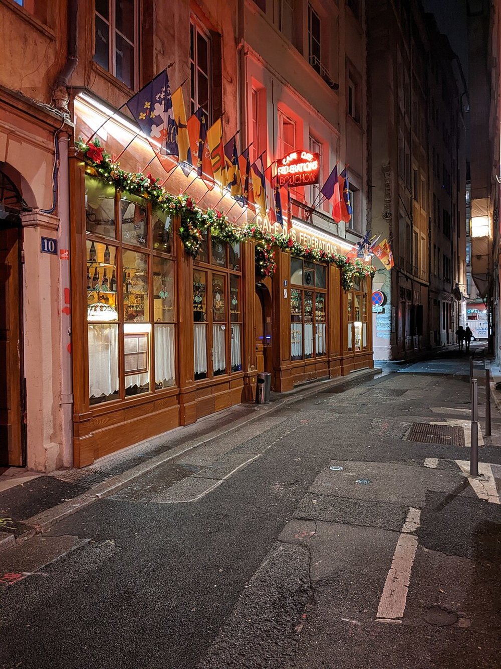 Exterior of Le Café des Fédérations, a traditional Lyonnaise bouchon at night