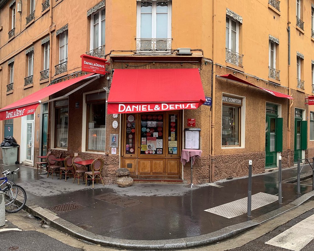 Saône River cruise boat passing historic Lyon buildings on a sunny day