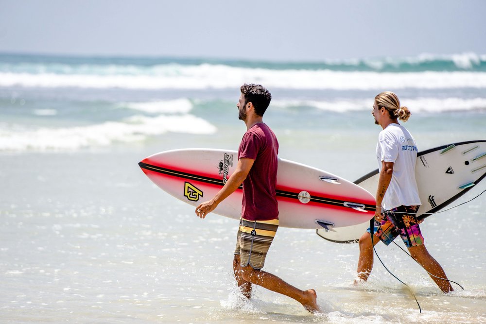 Surfers walking around Point Leo Beach
