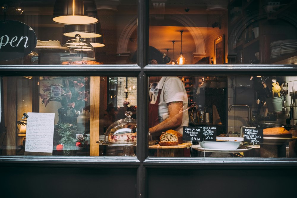 London bakery window with cakes, bread, and pastries displayed behind glass
