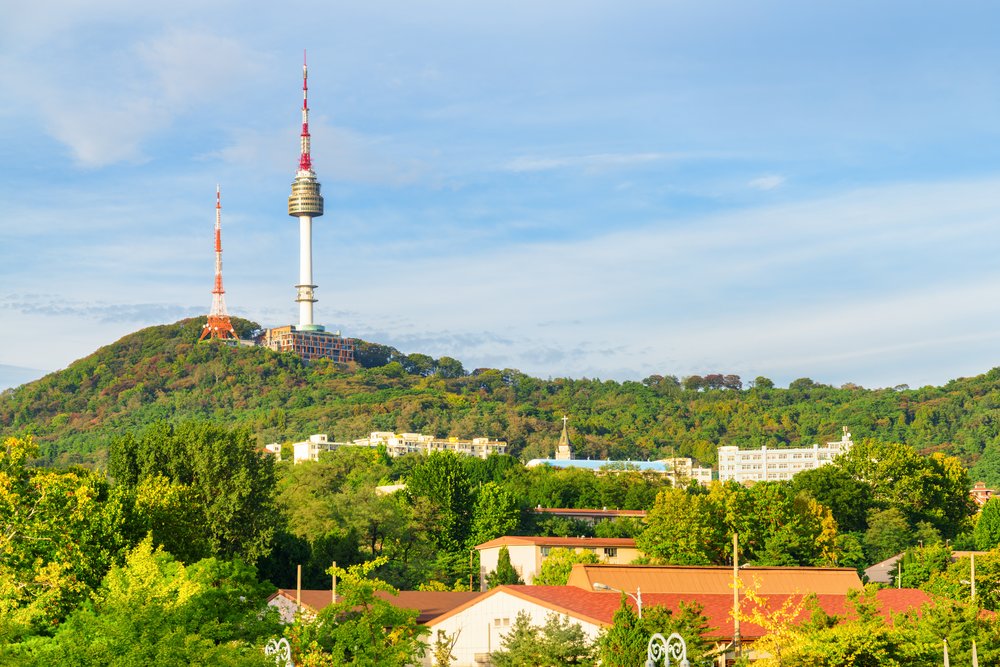 N Seoul Tower overlooking Seoul with lush greenery in summer