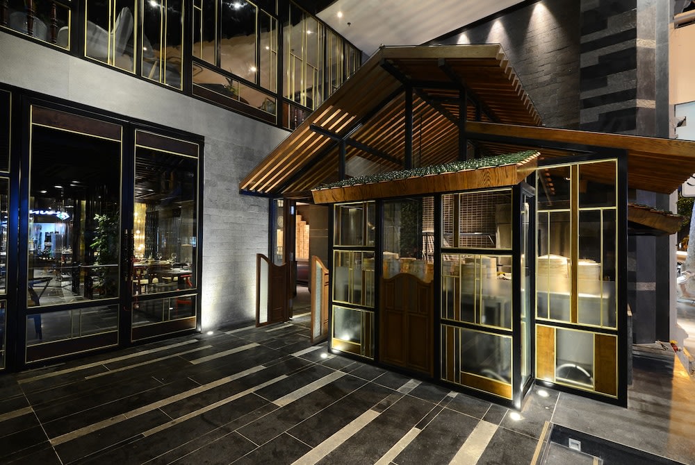 Boutique hotel exterior in Hanoi with modern architecture and evening lighting