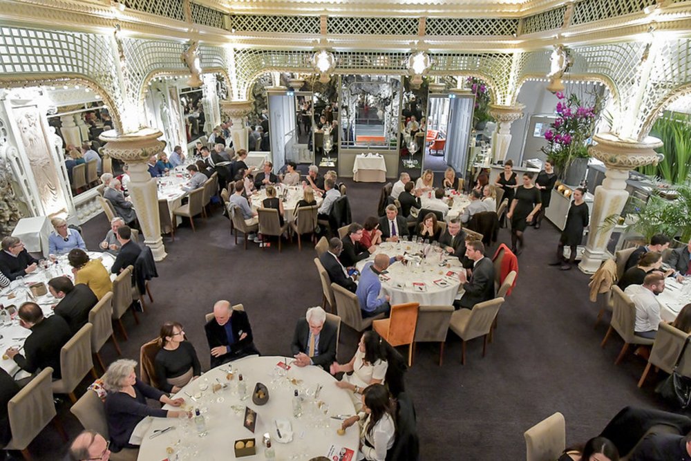 Interior of a fine dining restaurant in Bordeaux with guests seated at round tables