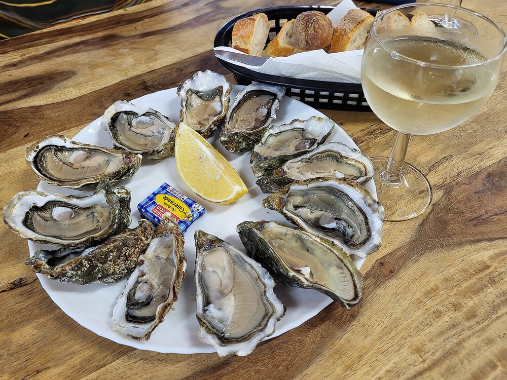 Plate of oysters with lemon and white wine at a Bordeaux seafood restaurant