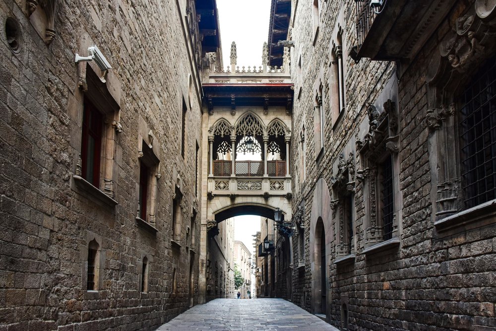 Narrow stone street in Barcelona Gothic Quarter with historic architecture