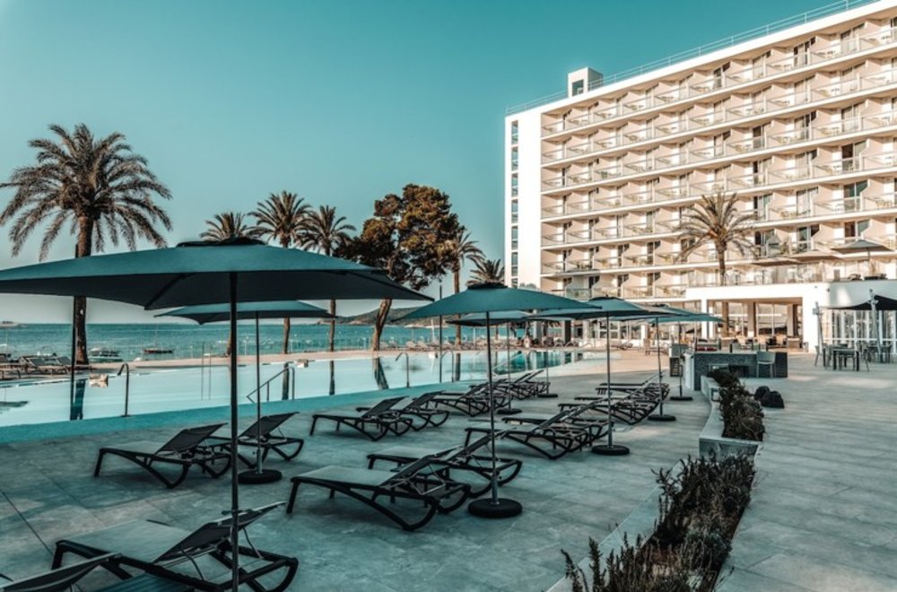 Sun beds and umbrellas by a pool