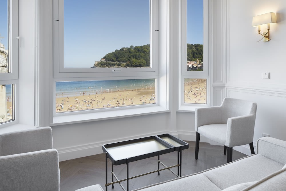 View of a beach from a well-furnished hotel room