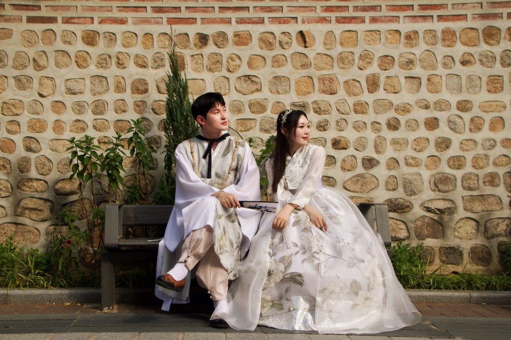 Couple wearing hanboks at Gyeongbokgung Palace  | Photo Credit: Klook