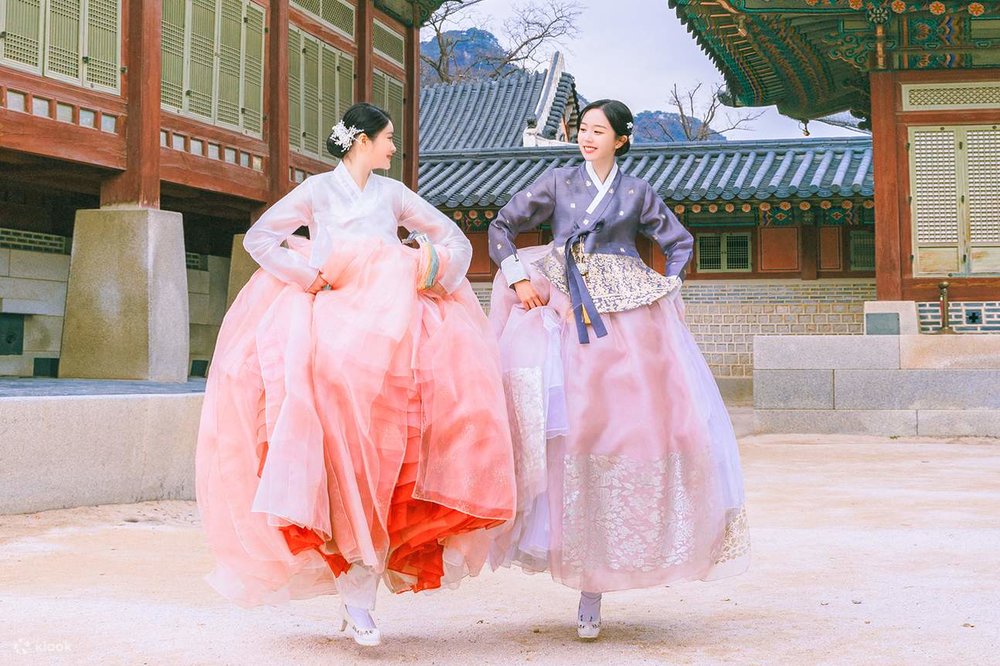 Travelers wearing hanbok at a historic palace in Seoul