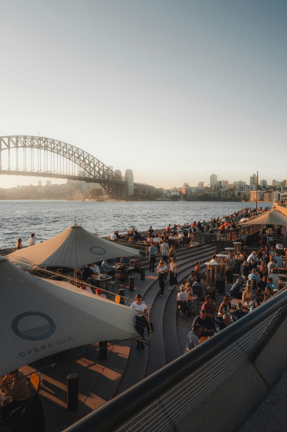 Outdoor dining area at Circular Quay showing people enjoying affordable food by Sydney Harbour