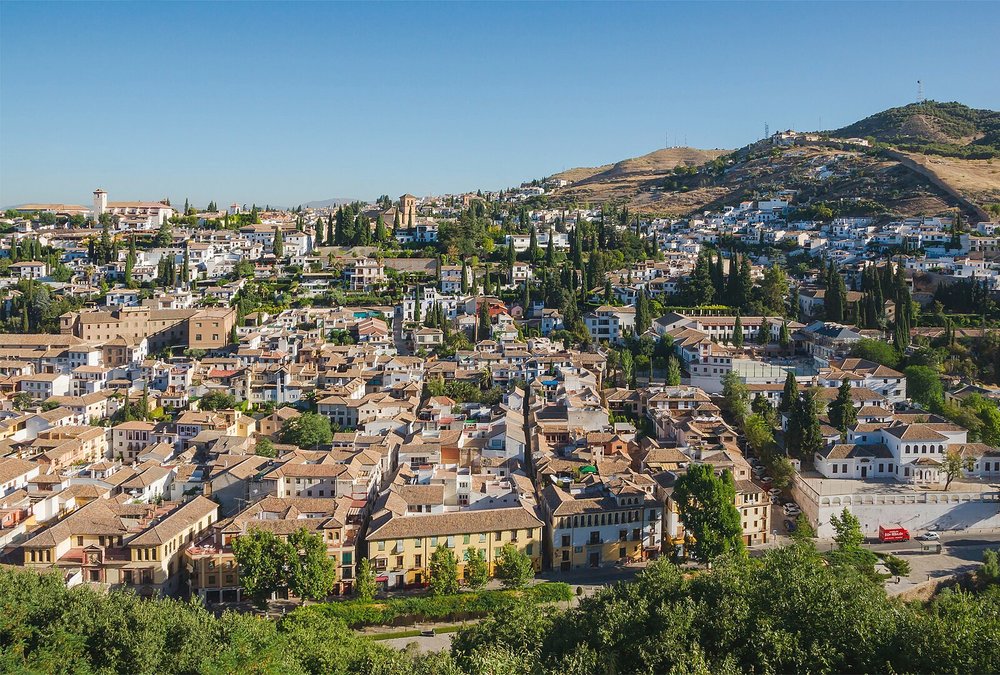 White houses of Albaicín with hills and historic Granada skyline