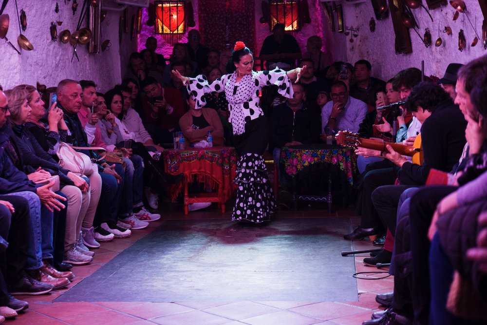 Flamenco dancer performing in a cave venue in Granada