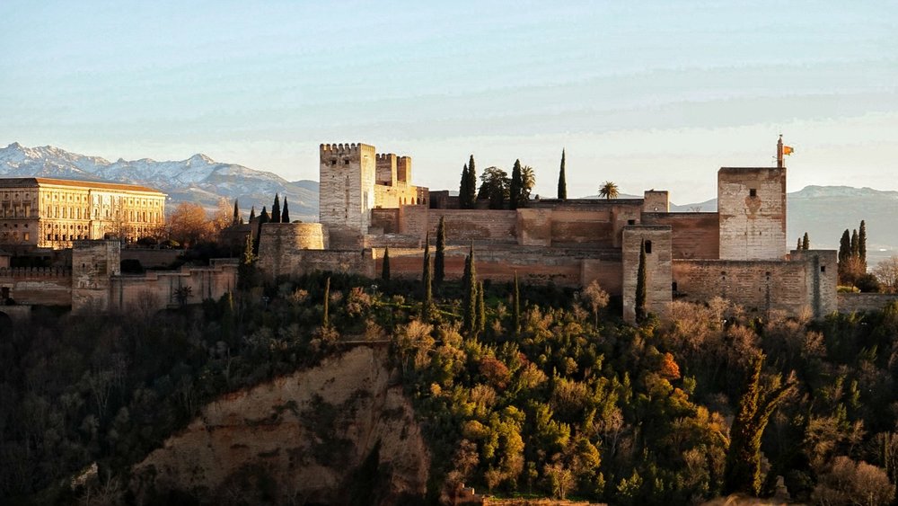 Alhambra palace walls above Granada with Sierra Nevada mountains