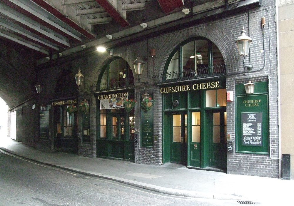 Historic Ye Olde Cheshire Cheese pub entrance under brick arches in London
