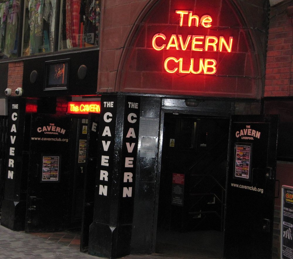 Entrance of The Cavern Club in Liverpool with glowing neon signage at night 