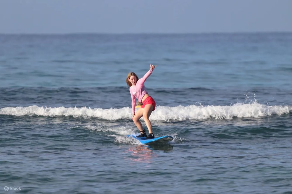 A woman surfing in Waikiki Beach